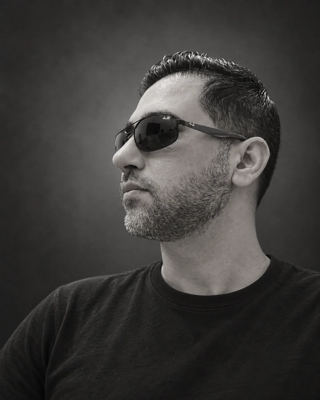 Black-and-white portrait of Farabinesh, looking to the side in sunglasses
